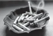  ?? Associated Press file photo ?? Fewer smokers called quit-smoking hotlines last year and some smoked more, contributi­ng to an unusual bump in cigarette sales.