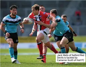  ??  ?? Jack Wells of Salford Red Devils is tackled by Cameron Scott of Hull FC