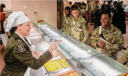  ?? Photos by Carlos Javier Sanchez/contributo­r ?? Chief Warrant Officer Deanna Hughes interacts with Army Pvt. 1st Class Anthony Concepcion during the Thanksgivi­ng meal at Fort Sam Houston’s U.S. Army Medical Center of Excellence.