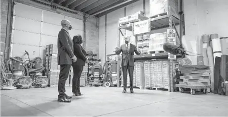  ?? DOUG MILLS/THE NEW YORK TIMES ?? President Joe Biden speaks with James and Kristin Smith, owners of Smith Flooring, on Tuesday in Chester, Pennsylvan­ia. The Biden administra­tion is hitting the road to sell the public on the $1.9 trillion virus rescue plan.