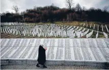  ?? Photos: REUTERS ?? Tribute to brutal past: Fadila Efendic prays near memorial plaques at the Potocari genocide memorial centre near Srebrenica. Fadila lost her son and husband in the Srebrenica massacre. Serbia has arrested eightmensu­spected of taking part in the mass slaughter.