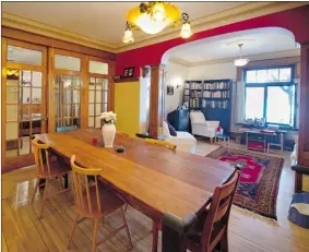  ?? PHOTOS: PETER MCCABE/ THE GAZETTE ?? Paul Edmond Robichaud and Isabelle Lafortune found their dining room table, which comes from India, at a store on St. Laurent Blvd. “Believe it or not,” Robichaud says, “the top is made from teak railway ties.”