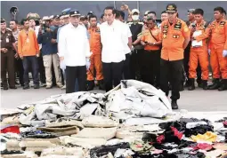  ??  ?? TRAGEDY – Indonesian President Joko Widodo visited the Jakarta port, October 30, where bodies and debris from the Lion Air crash are being unloaded. (AP)