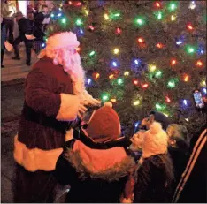  ??  ?? Children surrounded Santa Claus as he switched on the lights on the tree in front of the Rockmart History Museum on Friday, Dec. 7 to cap of the 2018 Christmas Parade.