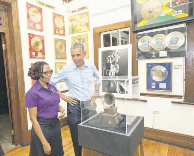  ?? AP PHOTOS ?? US President Barack Obama visits the Bob Marley Museum with tour guide Natasha Clark. Wednesday, April 8, 2015 in Kingston, Jamaica