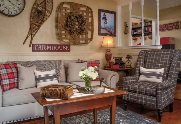  ??  ?? Above: A textured wall treatment is the backdrop for a tobacco basket and snowshoes in the family room. Red books, pillows and signs brighten the otherwise neutral corner.