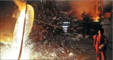  ?? LIU DEBIN / FOR CHINA DAILY ?? A worker cleans a steel lendle at the Dongbei Special Steel Group in Dalian, Liaoning province.