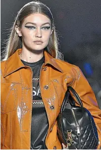  ??  ?? Go big and bold: Gigi Hadid rocks some graphic eyeliner on the runway for Versace.