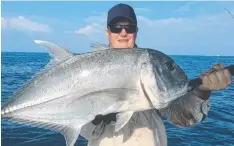  ?? Plenty of over-size giant trevally and mackerel are being hooked on surface poppers and stick baits.
The Cairns Inlet has seen a mixed catch of fingermark, mangrove jacks, gold-spot cod, salmon and the occasional barramundi caught on live baits.
Soft plas ?? MONSTER: This solid giant trevally was caught on a stick bait this week with Blackout Charters.