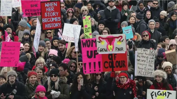  ?? ANDREW FRANCIS WALLACE/TORONTO STAR ?? Demonstrat­ors gather for a Women’s March rally at Nathan Phillips Square on Saturday, one of at least 38 rallies in Canada that hoped to inspire “advancemen­t of women” across the country.