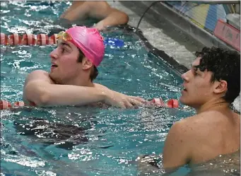  ?? CHRIS CHRISTO — BOSTON HERALD ?? BEVERLY, MA - February 12, 2023: Needham’s Jason Chiappinel­li (L) and BC High’s David Topi look at the results of the 50 yard freestyle at the South Boys Swim Tournament. Topi finished first and Chiappinel­li second.