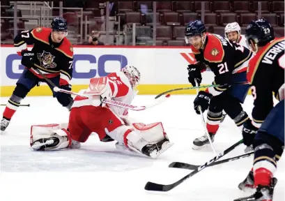  ?? GREGORY SHAMUS Getty Images ?? Alex Wennberg (21 ) puts the puck past Detroit goalie Jonathan Bernier to give the Panthers a 1-0 lead in the first period Saturday. It wasn’t enough to hold up after the Red Wings scored two goals in the second period.