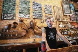  ?? JOHN MINCHILLO PHOTOS / AP ?? Shane Juhl, owner and proprietor of Toxic Brew Co., at his taproom located in the Oregon District in Dayton. After experienci­ng its best days in the first half of the 20th century, Dayton is reinventin­g itself with impressive results.