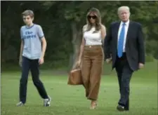  ?? CAROLYN KASTER - THE ASSOCIATED PRESS ?? President Donald Trump, first lady Melania Trump, and their son Barron Trump walk from Marine One across the South Lawn to the White House in Washington, June 11, as they return from Bedminster, N.J.