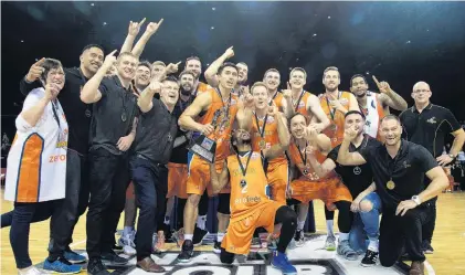  ?? PHOTO: PHOTOSPORT ?? Shark attack . . . The Southland Sharks celebrate after beating the Wellington Saints in the NBL final in Wellington yesterday.