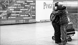  ?? ALEXANDER F. YUAN/AP ?? Abdullah Alghazali, right, hugs son Ali Abdullah Alghazali after the Yemeni teen arrived Feb. 5 at JFK airport in New York. Yemen remains one of six nations on the travel ban list.