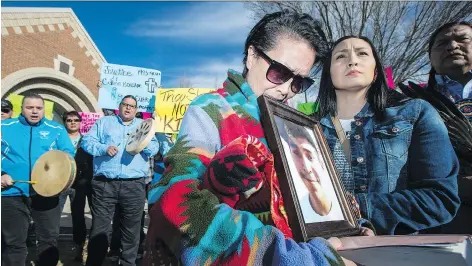  ?? LIAM RICHARDS ?? Colten Boushie’s mother Debbie Baptiste, left, holds a photo of her son as his cousin Jade Tootoosis comforts her outside North Battleford provincial court at Gerald Stanley’s preliminar­y hearing on April 6, 2017. Stanley is charged with second-degree murder in Boushie’s death.