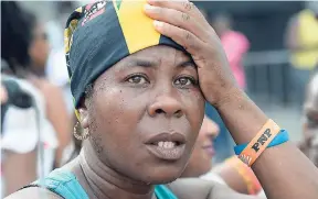  ?? FILE ?? One of the many persons who reacted with disbelief after Usain Bolt captured the bronze medal in the London World Championsh­ips 100m final.