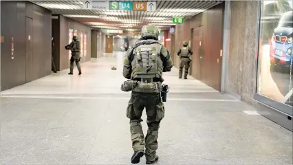  ?? PICTURE: EPA ?? Special police officers secure the area in the undergroun­d station Karlsplatz (Stachus) after a shootout in Munich, Germany, yesterday.