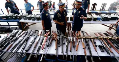  ?? —EDWINBACAS­MAS ?? Fifty-six rifles, 18 pistols, 27 hand grenades, 62 rifle grenades and over 17,000 rounds of ammunition were found inside a “secret room” at 36 Tandang Sora Ave., according to police.