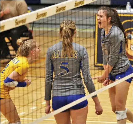  ?? GEORGE SPITERI — FOR MEDIANEWS GROUP ?? Birmingham Marian’s Izzy Busignani. right, reacts to winning a point against Clarkston during a Division 1state quarterfin­al match Tuesday
at St. Clair County Community College in Port Huron. Marian survived a five-set marathon, winning 15-25, 25-21, 15-25, 29-27, 15-8.