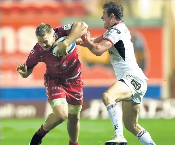  ??  ?? James Davies is tackled by Ulster’s Billy Burns in their Champions Cup clash at Parc y Scarlets on December 7.