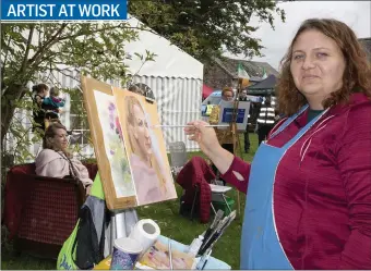  ??  ?? Artist Kate Kos paints a portrait of author Cat Hogan at the Kathleen Browne Festival in Bridgetown.