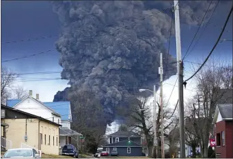  ?? GENE J. PUSKAR — THE ASSOCIATED PRESS ?? A large plume of smoke rises over East Palestine, Ohio, after a controlled detonation of a portion of the derailed Norfolk Southern trains Monday, Feb. 6, 2023. About 50 cars, including 10 carrying hazardous materials, derailed in a fiery crash. Federal investigat­ors say a mechanical issue with a rail car axle caused the derailment.