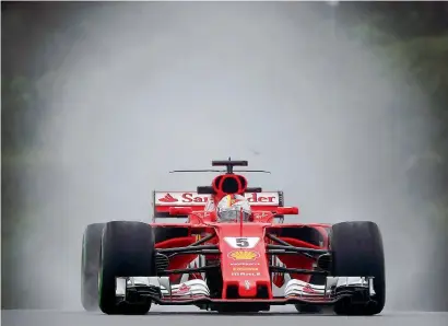  ?? Reuters ?? Ferrari driver Sebastian Vettel steers his car during the practice session for the Malaysian Formula One Grand Prix in Sepang. —