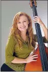  ??  ?? Bluegrass bassist Jeanette Williams leads her band Monday in Paragould.