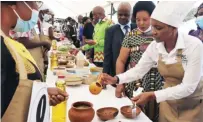  ?? ?? Tourism, Environmen­t and Hospitalit­y Industry Deputy Minister Barbara Rwodzi (in white) tours stands where women from Mashonalan­d East Province showcased their prepared traditiona­l foods during the Cookout competitio­n in Marondera spearheade­d by First Lady Amai Mnangagwa