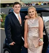  ?? PHOTO: KEVIN FARMER ?? SCHOOL’S OUT: Mark Smith and Justice Reis arrive in a golf buggy are at Clifton State High School formal at City Golf Club.