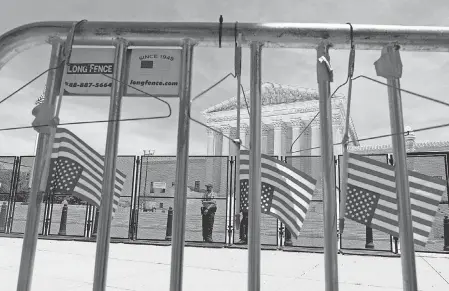  ?? JOSE LUIS MAGANA/ AP ?? Abortion- rights activists leave hangers on the fence as they protest outside the Supreme Court in Washington on July 4. After the Supreme Court’s decision to overturn Roe v. Wade and end the constituti­onal right to abortion it establishe­d in that 1973 case, there has been considerab­le angst over whether contracept­ion will be next.