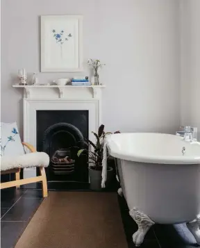  ??  ?? Left: Sarah Jane updated the family bathroom with slate-effect porcelain floor tiles – find similar at Topps Tiles. The bath is from Bathstore and the armchair from Argos. Walls are painted in Farrow & Ball’s Cornforth White. The Sea Holly cushion and print are available from Sarah Jane’s website