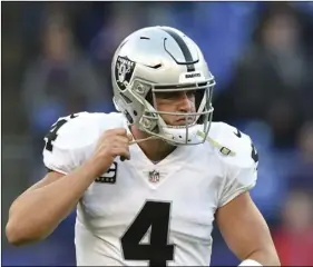 ??  ?? Oakland Raiders quarterbac­k Derek Carr removes his helmet straps as he walks off the field in the second half of an NFL football game against the Baltimore Ravens, on Sunday, in Baltimore. AP PHOTO/GAIL BURTON