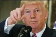  ?? PABLO MARTINEZ MONSIVAIS — THE ASSOCIATED PRESS ?? In this photo, President Donald Trump points to members of the media as he answers questions in the lobby of Trump Tower in New York.