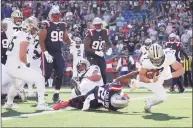  ?? Mary Schwalm / Associated Press ?? Saints quarterbac­k Taysom Hill (7) dives past Patriots strong safety Adrian Phillips (21) for a touchdown during the second half on Sunday in Foxborough, Mass.