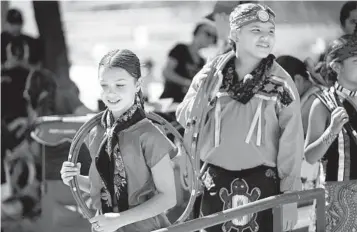  ?? ROSS D. FRANKLIN AP ?? Performers from the Native American Hoop Dance of Ballet Arizona walk to the stage at an Indigenous Peoples Day festival Monday in Phoenix. Seventeen states have holidays honoring Native Americans.