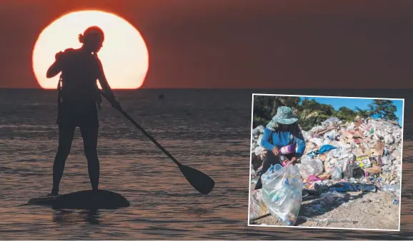  ?? Pictures: AFP ?? A paddleboar­der at the Philippine­s’ Boracay island ahead of the tourist destinatio­n’s closure this week for a six-month clean-up and (inset) Gina Galan, 45, collects discarded plastic bottles at the resort dumpsite, which President Rodrigo Duterte has...