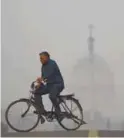  ??  ?? A man cycles near President’s House amid heavy smog in New Delhi yesterday.