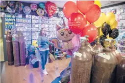  ?? JAMES HILL/THE NEWYORKTIM­ES ?? Anastasia Bukhiyeva uses Russian helium to fill balloons last month at a store in Moscow. A Siberian plant is expected to reshape the helium market.