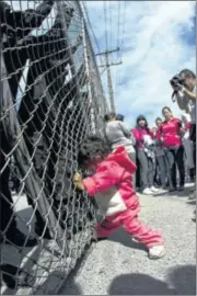  ?? AP PHOTO BY HANS MAXIMO MUSIELIK ?? A child yells out for her father as she pushes on a gate where police stand Sunday at the Apodaca correction­al facility in Mexico. Relatives were waiting to see if family members were alive.