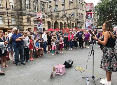 ??  ?? Foot-tapping: Lucy May Walker, playing on the Royal Mile, says card machines are a godsend