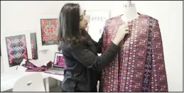  ?? (AP) ?? In this Jan 29, 2019 photo, designer Natalie Tahhan works on a modern version of thetraditi­onal Palestinia­n thobe in her studio in east Jerusalem.