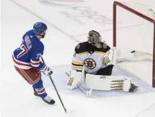  ?? ASSOCIATED PRESS ?? ELUDING THEM: Jaroslav Halak can only watch as the Rangers’ Tony DeAngelo scores the shootout winner, handing the Bruins a 4-3 loss last night in New York.