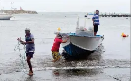 ?? ASSOCIATED PRESS ?? MEN REMOVE A BOAT FROM THE WATER AHEAD of Hurricane Maria in the Galbas area of Sainte-Anne on the French Caribbean island of Guadeloupe early Monday.