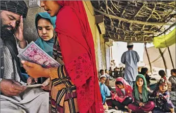  ?? Photograph­s by Marcus Yam Los Angeles Times ?? CHILDREN attend a coed religion school in Arghandab, a Kandahar district that was liberated when government forces managed to claw back gains made in the last six months by Taliban fighters.