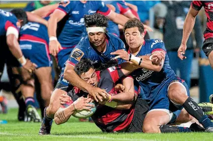  ??  ?? Canterbury’s Rob Thompson scores in the combined tackles of Tasman’s Shane Christie and David Havilli during the Mitre 10 Cup premiershi­p rugby final.