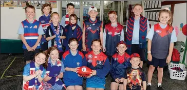  ??  ?? Sacred Heart Primary School students donned their AFL team jumpers last week as excitement builds for this Saturday’s AFL grand final. With the football are Year 5 student Bailey Richardson and Ruby Driscoll from Year 4.