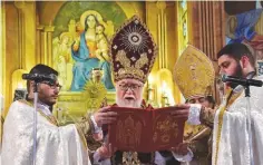  ??  ?? ALEPPO: Aram I, Armenian Catholicos of the Holy See of Cilicia, leads the Armenian Christmas Day service at the Saint Mary Armenian Apostolic church in Aleppo yesterday. — AFP